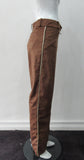 Brown Faux Suede Trouser. Nicely tailored medium brown faux suede trousers with beige contrast piping. Front angle invisible zip pockets. Can be paired with 060218 Split Suede Coat. Formerly a showpiece, specially made. Inseam 83cm. Outseam 103cm. 400g approximate weight. 95% Polyester, 5% Nylon. Dry Clean Only. Made in Canada