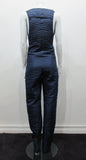 Full length one-piece brace jumpsuit with a sequin contrast panel. Twin brocade buttons on shoulder points.