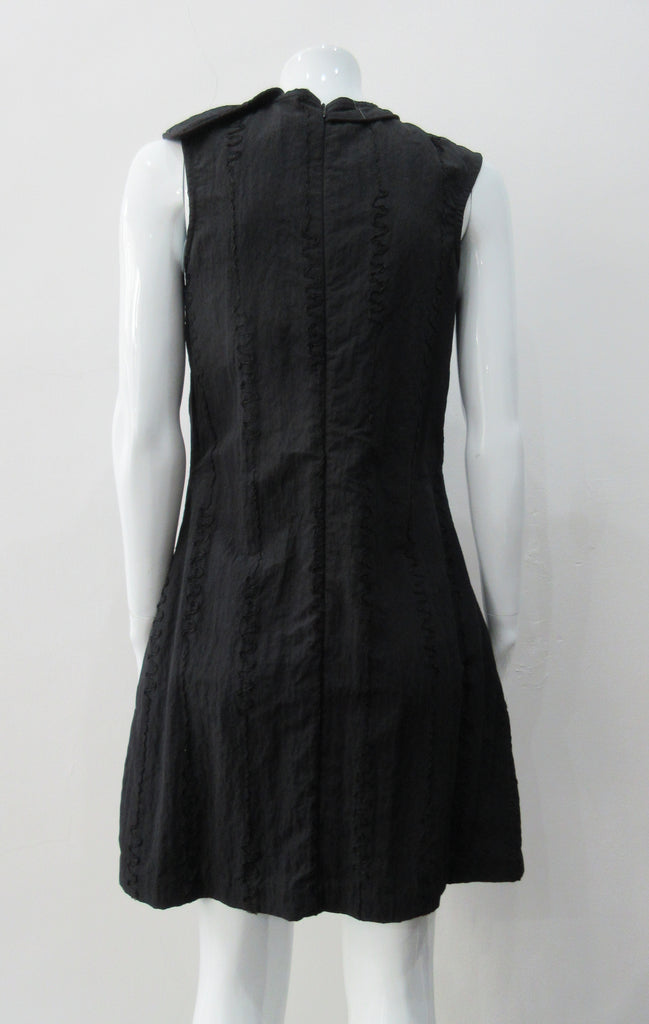 Black Flap Shoulder Dress. The ideal little black sleevelss dress featuring assymetric styling with piping. CB invisible zipper. Fully lined. Size 8