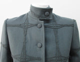 Wobbler Jacket. Tailored jacket with button collar and covered buttons in deep taupe grey, with a slight military feel. Features neo-classical trim design which naturally becomes fuzzy over time as a design detail. Size 8