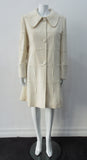Generously cut 3/4 length coat with large rounded collar and covered buttons in off white, with a slight military feel. Features neo-classical trim design which naturally becomes fuzzy over time as a design detail. Size 12