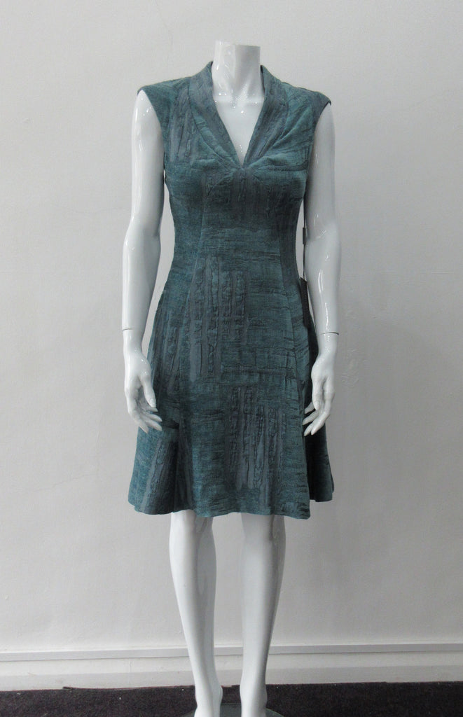 Round Seam Dress. Dark sea green textured dress with curved neck panels. With CB zipper. CB length 93cm. 82% Wool, 18% Nylon. Lining: 100% Rayon. Dry Clean Only, Made in Croatia
