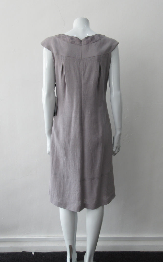 Pleated Cross Seam Dress. Blue-Grey dress with cross seam panel details. Falls below the knee. 65% Linen, 35% Cotton. Contrast: 58% Nylon, 42% Polyester Lining: 100% Rayon Dry Clean Only. 250g approximate weight. Made in Croatia