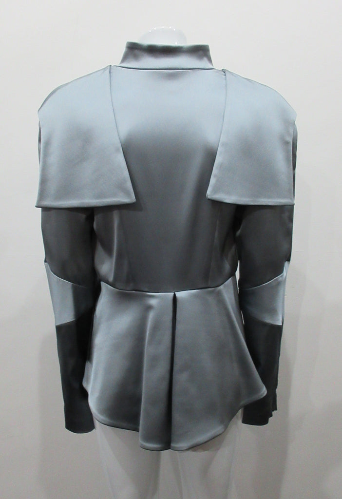 Grey-Blue flap panel short jacket, with pleated peplum. Heavier weight fabric ideal for colder weather wear. CF and sleeve hem zippers.