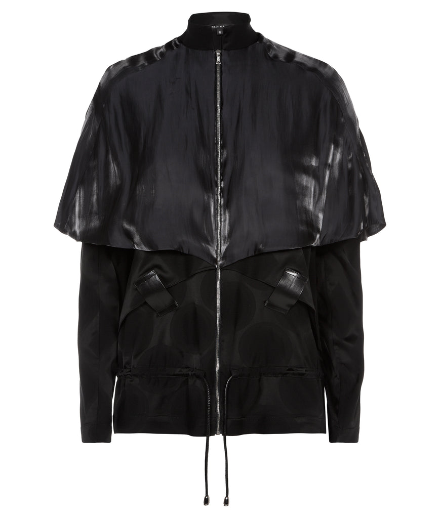 Black cropped jacket with shiny satin cape over shoulders in a relaxed fit. Geometric weave on fabric in black colour. Faux leather trim and toggle waist. CF metal zipper. 450g approximate weight. 64% Wool, 36% Silk. Contrast: 100% Nylon. Dry Clean Only. Made in England