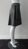Piped Pocket Skirt. Medium length medium grey wool blend A-line skirt with slight swing. Blue piping and sport trim on sides. Side pockets included. CB zipper; CB length 46cm. 700g approximate weight. 51% Acrylic, 42% Wool, 4% Nylon, 2% Polyeurethane Lining: 100% Rayon Dry Clean Only. Made in Canada