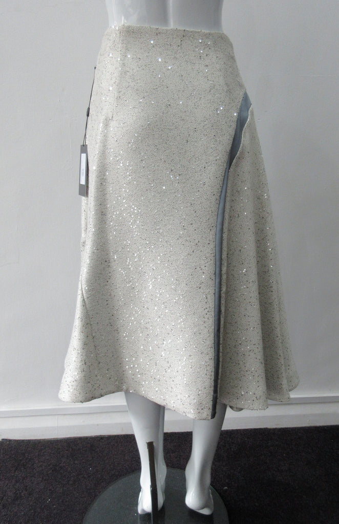 Plain Curve Panel Skirt  Assymetrical gathered toggled skrit in grey-white colour. Grey seam panel can be gathered to create raised ruching effect. Featuring textured tweed style with spaced sequins. Large metal side front detaching zipper. CB length 80cm. 600g approximate weight. 36% Polyester, 28% Viscose, 35% Cotton, 5% Lycra. Dry Clean Only. Made in England