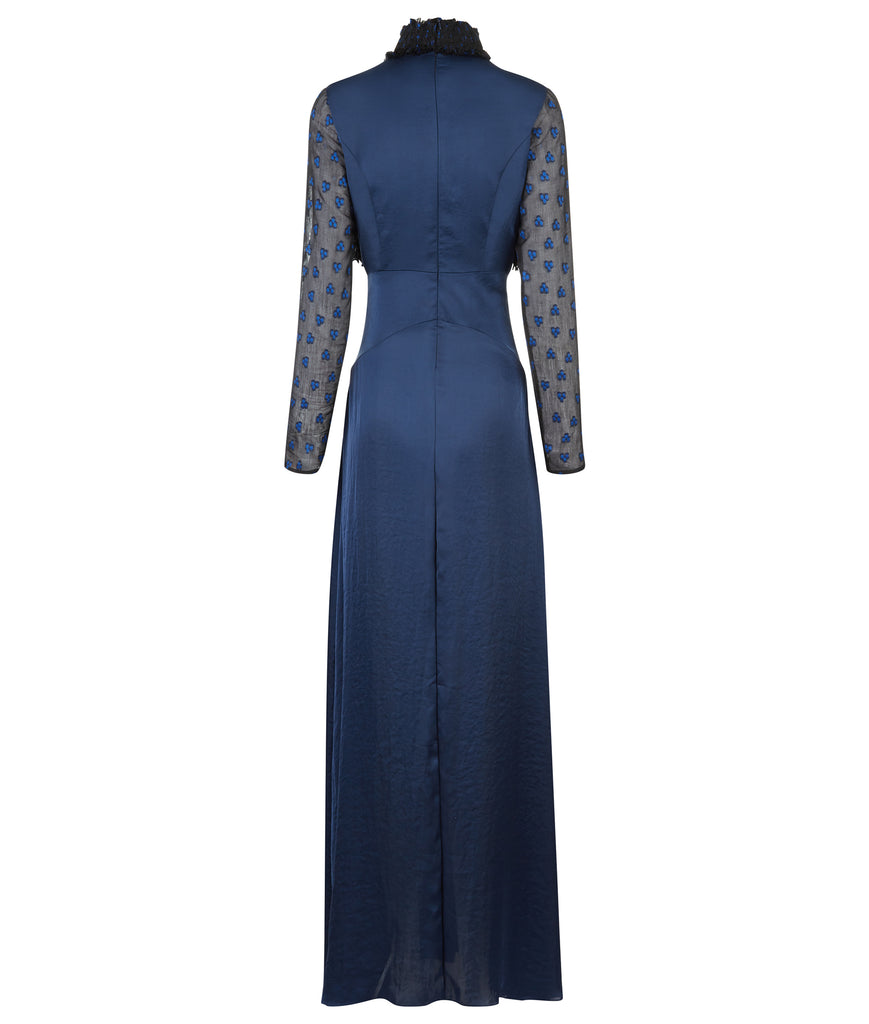 Full length long sleeved blue dress featuring pleats and gathers above and beyond waist panel. Glitzy bust area in shiny metallic textured fabric. High ruched collar, with loosing top threads as a natural effect of ruching process. CB zipper. 800g approximate weight. 100% Polyester. Contrast: 90% Polyester, 10% Nylon. Dry Clean Only. Made in England