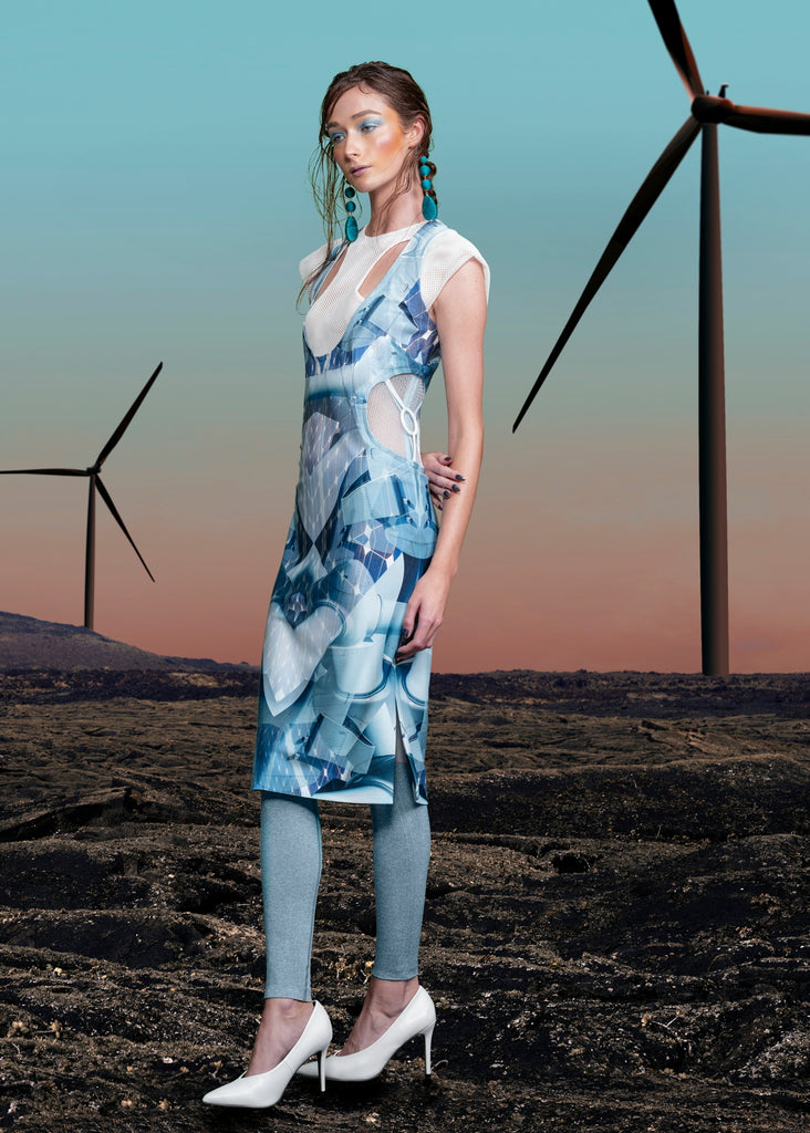 Print Round Waist Dress. Multi-blue coloured wind turbine print dress with dropped front neck, compensating with sheer white mesh on chest and shoulder tips. Turine blade style detail on side hips featuring tri-elastic trim groupings.