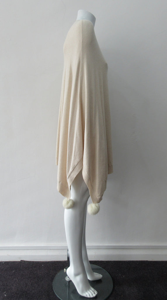 Generous cut swing poncho for greater ease and comfort. 4 fuzz balls located at corner points. Art. 4461, 52% Viscose, 35% Modal, 8% Elastic, 5% Cashmere. Dry Clean Only, Made in Italy, CB Length 81cm approximate.