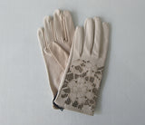 Beige Floral Cutout Gloves. Item Number D540NSF ICING 5358.0574. Beige Leather Gloves with floral cut-out design on top hand. Made in Italy. 60g approximate weight.