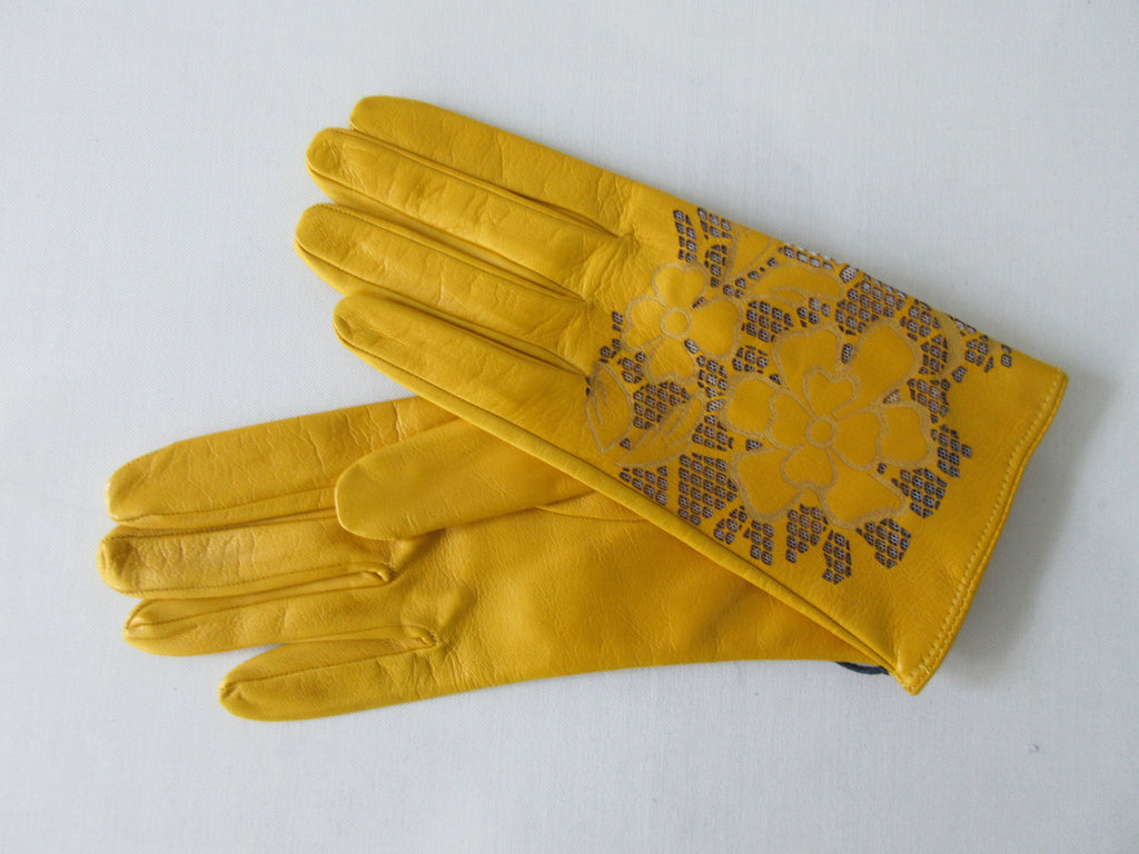 Yellow Floral Cutout Gloves. Item Number D540NSF Giallo Charo 6356.0574. Canary Yellow Leather Gloves with floral cut-out design on top hand. 60g aproximate weight. Made in Italy 